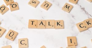 The word talk is spelled out in scrabble letters