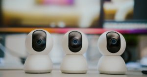 Webcam security camera. Smart home monitoring equipment on home office table.